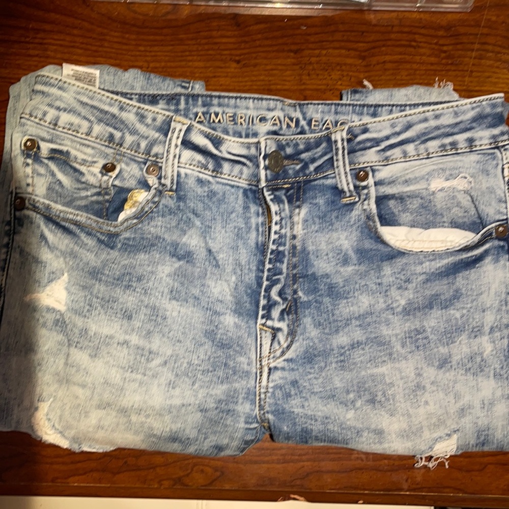 Ripped skinny jeans, blue and “acid washed” lightly worn American Eagle